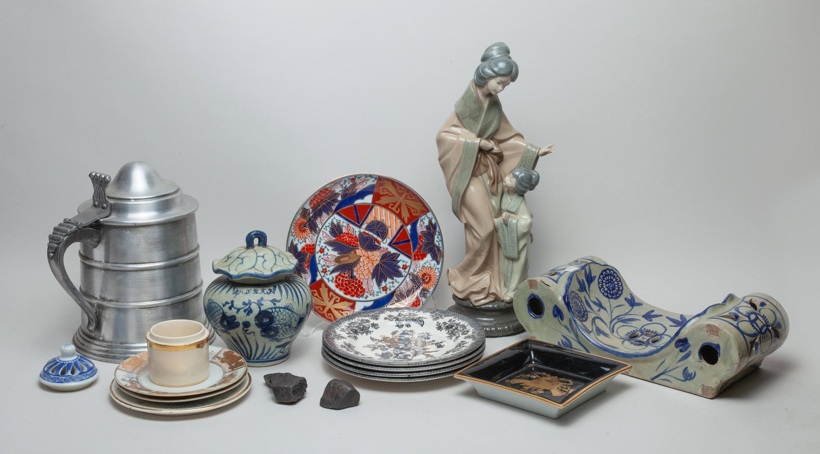 Estate Porcelain Decor: Including porcelain plates, a figure sculpture, a pillow, a covered jar, and a vintage pot. 9.3inch H, 8inch L, 7.4inch W (pot size).