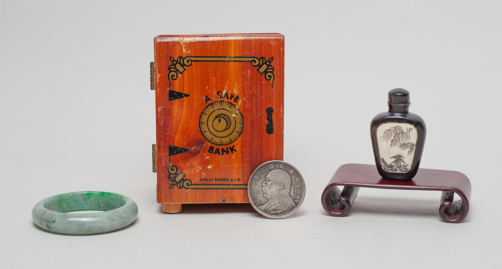 Estate Chinese Bangle, Coin & Bottle: Including a bangle, a Chinese one dollar coin, a bottle decorated with landscape scene on one side and a wine cup on the verso, a stand and a box. 2.75inch outer diameter, 2.15inch inner diameter (ban
