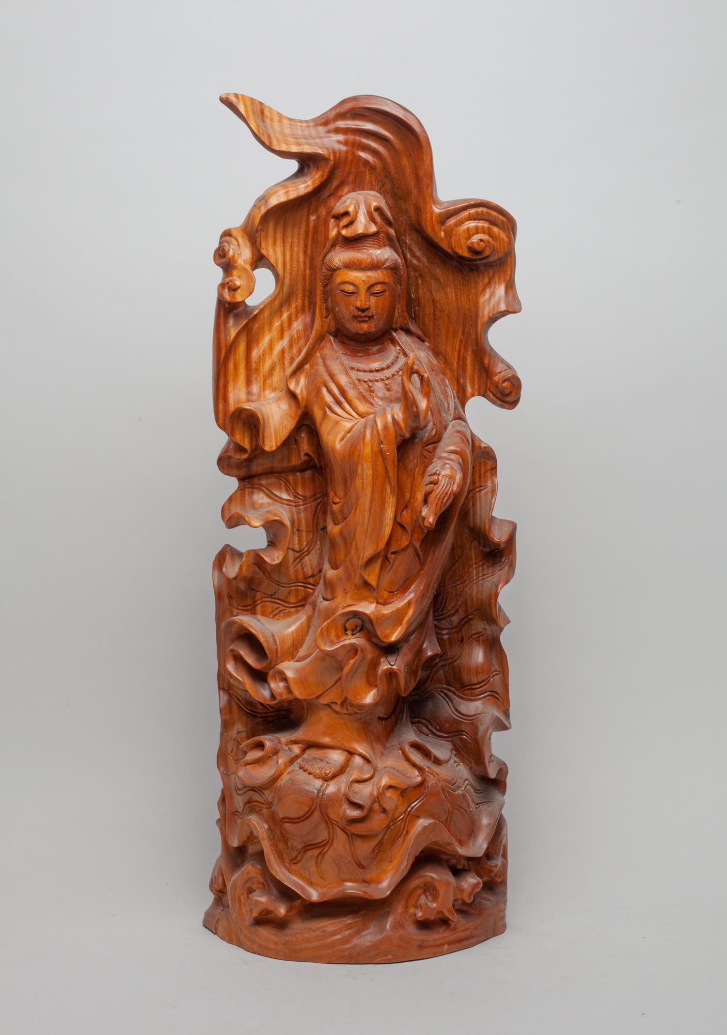 Tall Chinese Wood Carving of Kuanyin: Collectible wood carved tall Kuanyin, standing on lotus leaf, left hand holding a bottle and right hand in vitarka mudra. 22inch H, 8inch L, 3.5inch W.