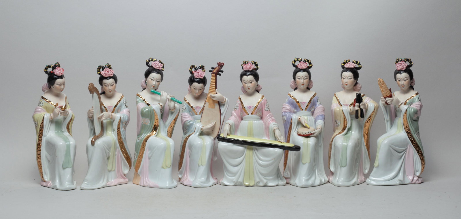 Chinese Export Porcelains: Group of 8 Chinese glazed porcelain figurines, molded as elegant females playing instruments. 9.2inch H, 3.5inch L, 4.2inch W (largest).
