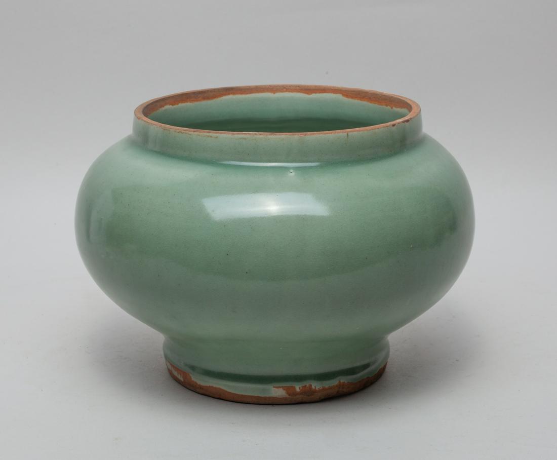 Large Chinese Longquan Porcelain Vase: Of compressed globular form, covered overall in celadon glaze save for the mouth and foot rim. 6.5inch H, 9.5inch W.