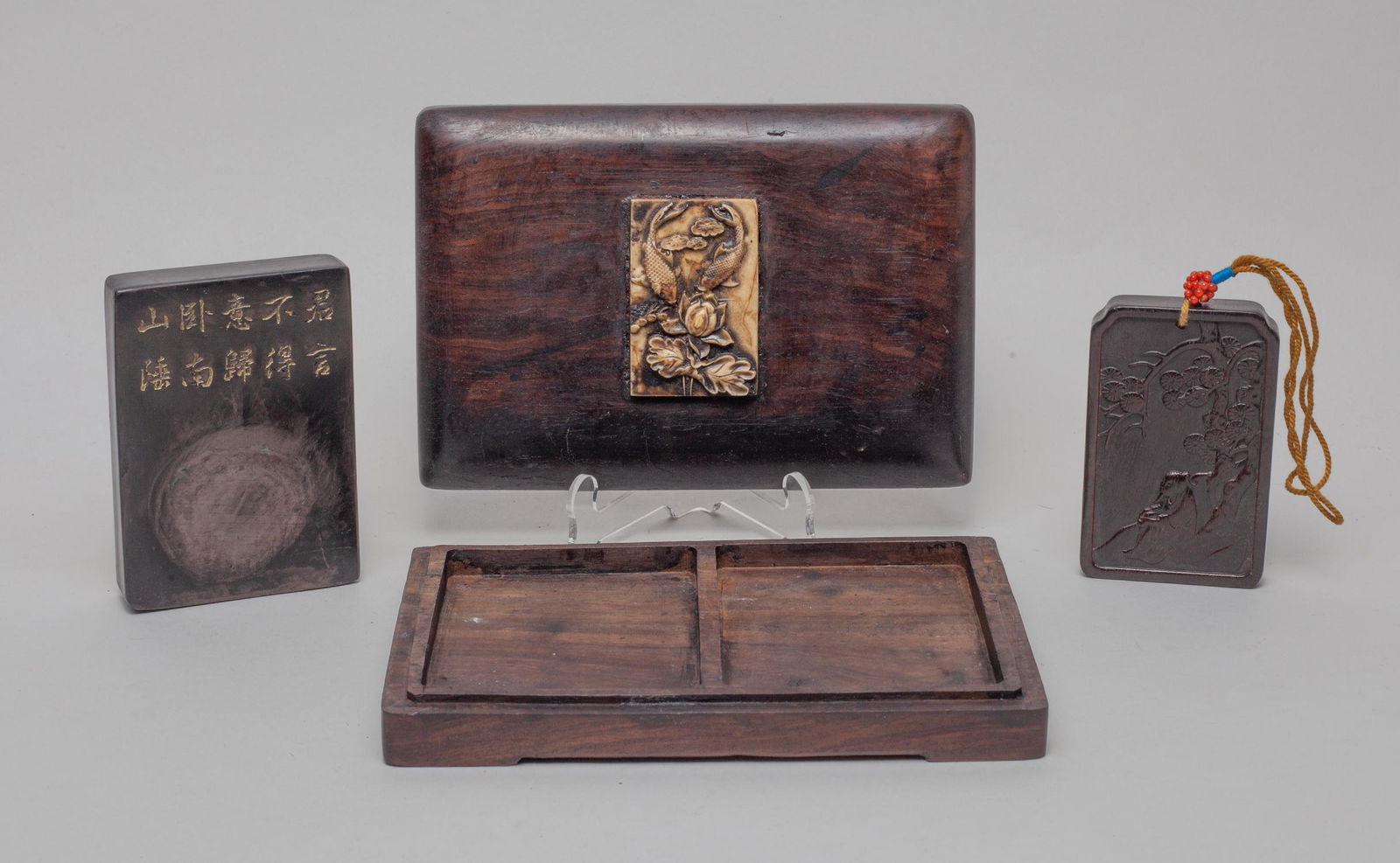 Chinese Ink & Wood Sets: Including a wood plaque carved with a scholar under a pine tree, an ink stone with poem inscription, with wood box carved with fish and lotus. Approx. 6.6-4.5-1.7 inch (box size).