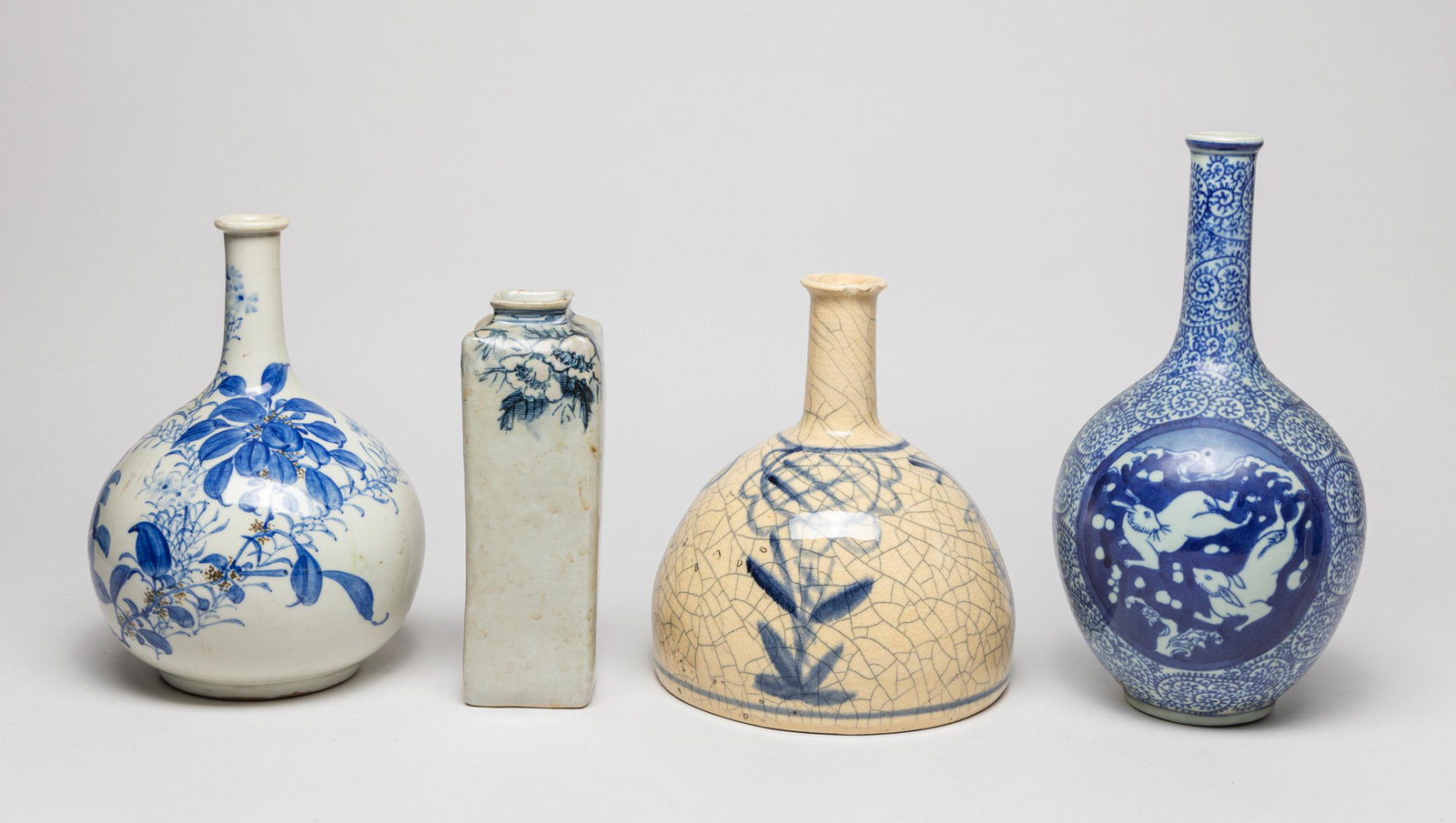 Korean/Japanese Porcelain Vases: Group of 4 Korean/Japanese blue and white porcelain vases, decorated with flowers. Approx. 8-7 inch (largest).