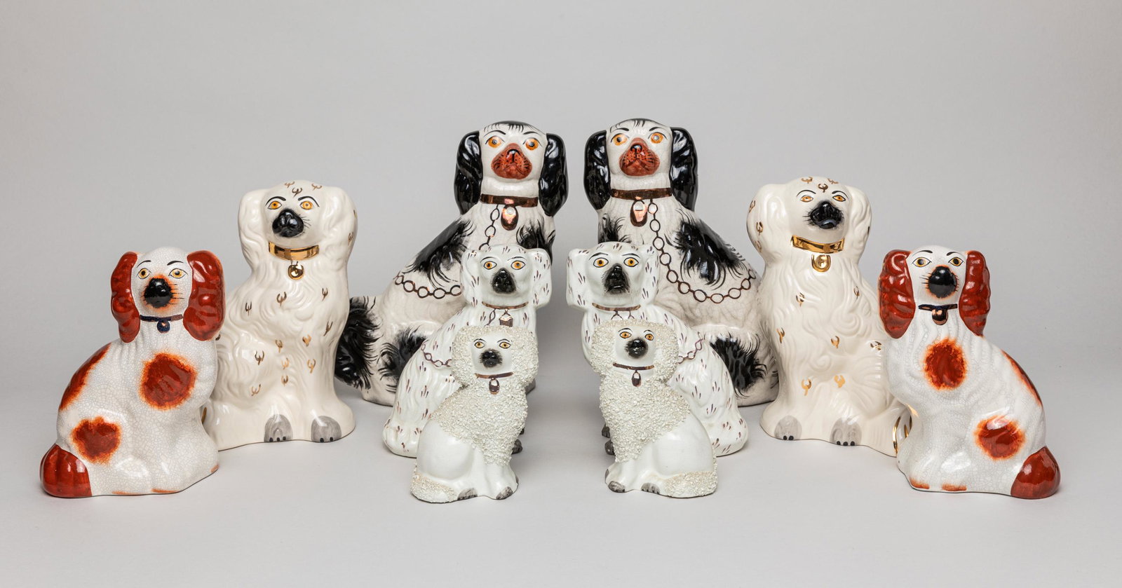 Collectible Kent Staffordshire Porcelain Dogs: Group of 5 pairs of decorative Kent Staffordshire porcelain dog sculptures, in white, rust and black colors with gilt highlights. Approx. 9-8.2-3.2 inch (largest).