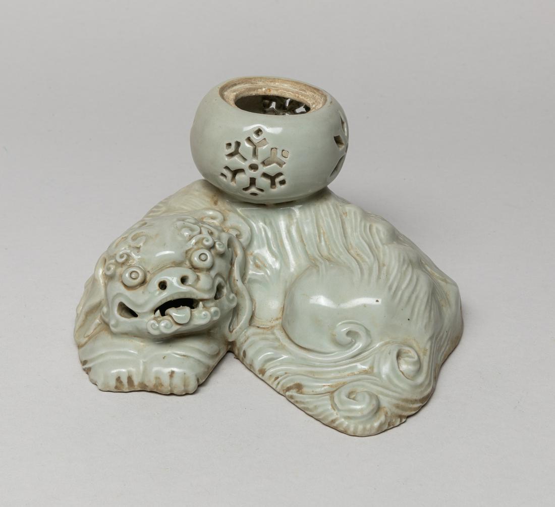 Rare Korean Joseon Porcelain Sculpture: Modeled in form of a recumbent beast supporting a globular bowl, carved in openwork with flowers, the exterior applied in white glaze. Approx. 6.4-5.1-3.5 inch.