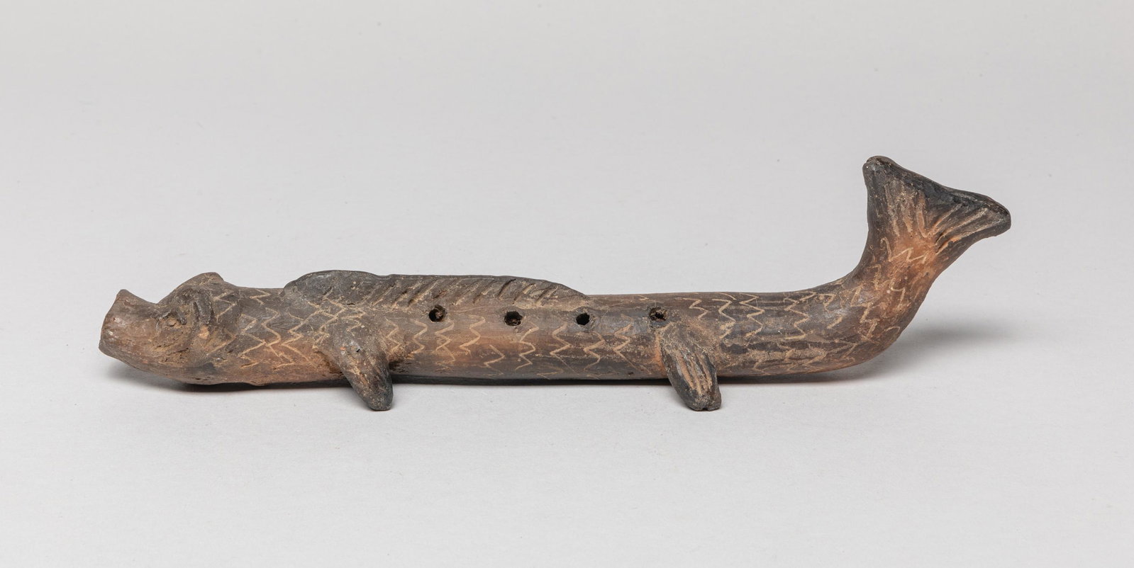 Antique Pacific Ocean Clay Flute: Sepcial antique clay long fish form flute. Approx. 10-2.6 inch.