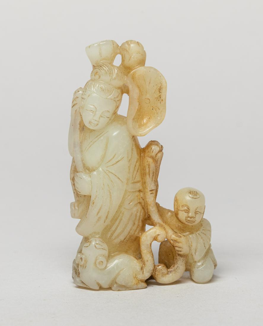 Chinese Russet Jade Sculpture: Depicting a standing female holding a long stem issuing lotus bud, seedpod and leaf, with a crouching boy and a beast around her. Approx. 3.2-1.9-1 inch.