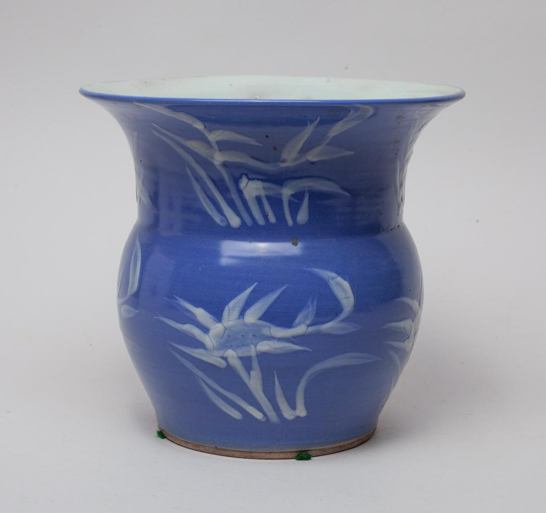 Antique Chinese Porcelain Vase: The exterior decorated with stylized lotus and orchids in white color reserved on an even purple-blue ground. 7.6inch H, 8.3inch D.