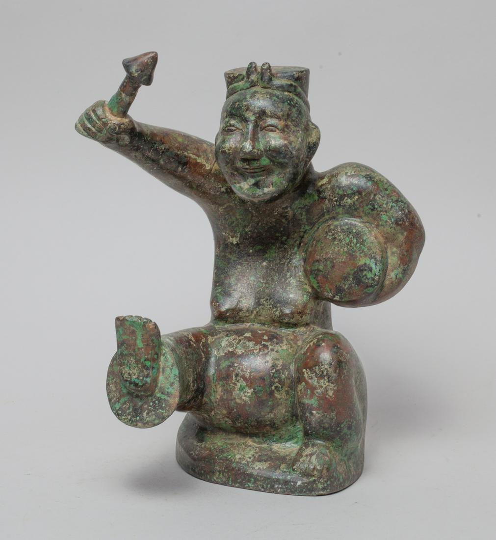Collectible Chinese Bronze Sculpture: Cast in form of a smiling figure with left arm carrying a drum and right hand holding a drumstick. Approx. 10-7-6.5 inch.