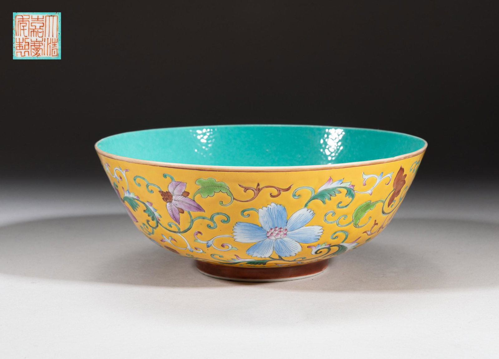 Chinese Famille Rose Porcelain Large Bowl: The bowl exterior enameld with lotus scrolls on royal yellow ground, the interior and bottom glazed in turquoise tone, the bottom with six-character mark. Approx. 7.2-2.7 inch. The Estate of Pasadena,