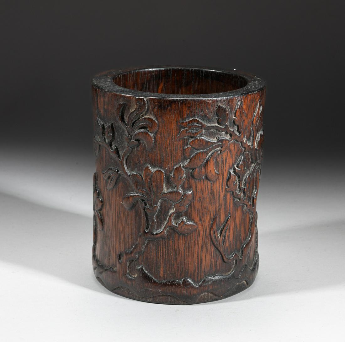 Chinese Bark of Agarwood Brush Pot: Of cylindrical form, the exterior carved in high relief with blossoming flowers. Approx. 5.7-4.9 inch. The Estate of Pasadena, 2023.