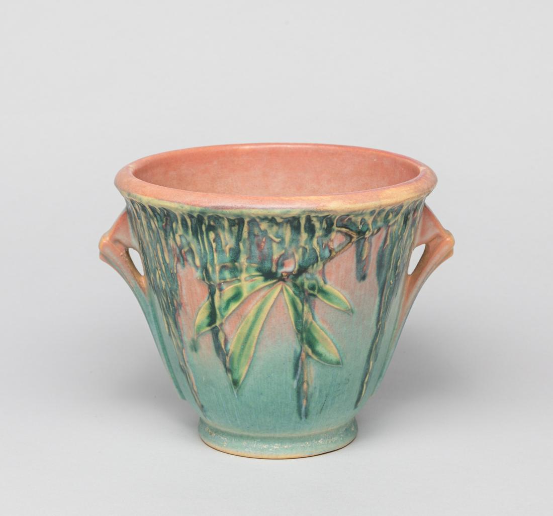 Roseville Earthen Ware Flower Pot: The pot exterior carved and painted with leafy stems, the bottom pierced with an aperture and carved Roseville 637-5. Approx. 6.7-6.1-5.2 inch.