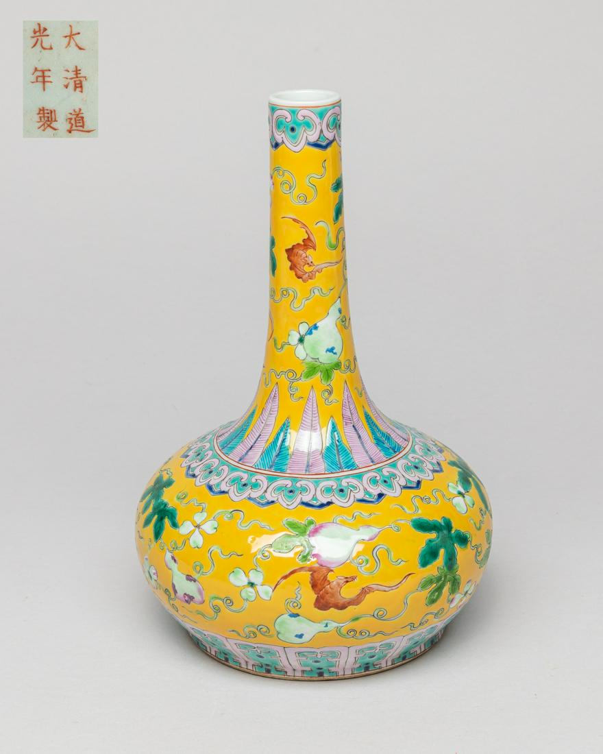 Chinese Enameled Porcelain Vase: The compressed body rising to tall slender neck, the exterior enameled with gourd vines and bats on yellow ground, between bands of ruyi heads and leaves or bands of ruyi heads and lappets, the bottom