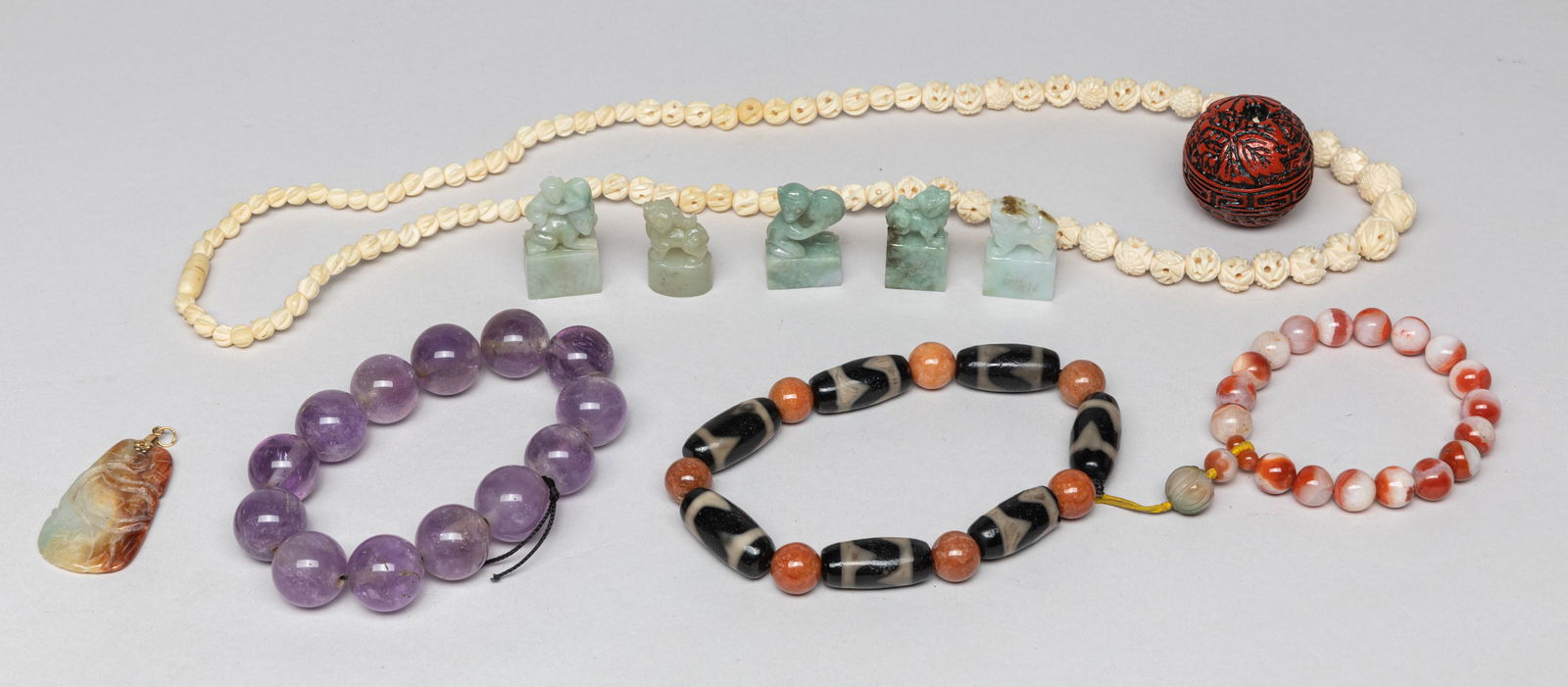 Chinese Amethyst, Agate & Dzi Beads: Including amethyst prayer beads, agate beads, dzi beads, jadeite seals, a russet stone pendant, a clay large bead and a bone bead necklace. Approx. 31inch L (necklace size).