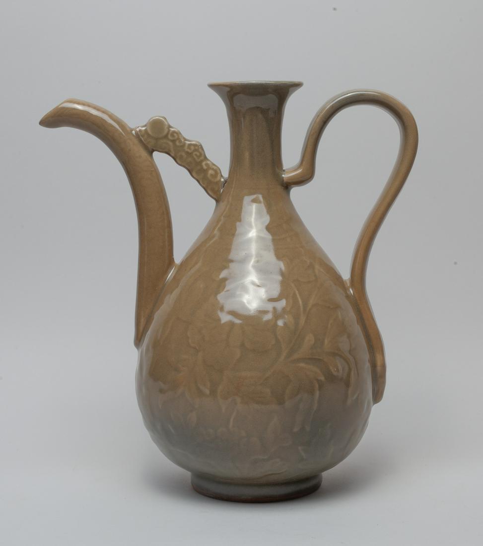 Massive Chinese Yaozhou Porcelain Pot: The pear-shaped body ring to a waisted neck and flared rim, carved the exterior in low relief with foliage scrolls, covered overall in soft brown glaze. Approx. 12-11-7 inch.