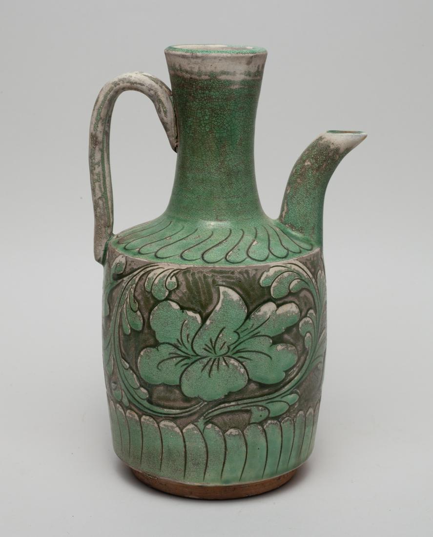 Chinese Cizhou Porcelain Pot: The cylindrical body rising to waisted neck, carved and painted with flowers between bands of petals, applied in crackled green glaze. Approx. 9.4-5.8-4.7 inch.