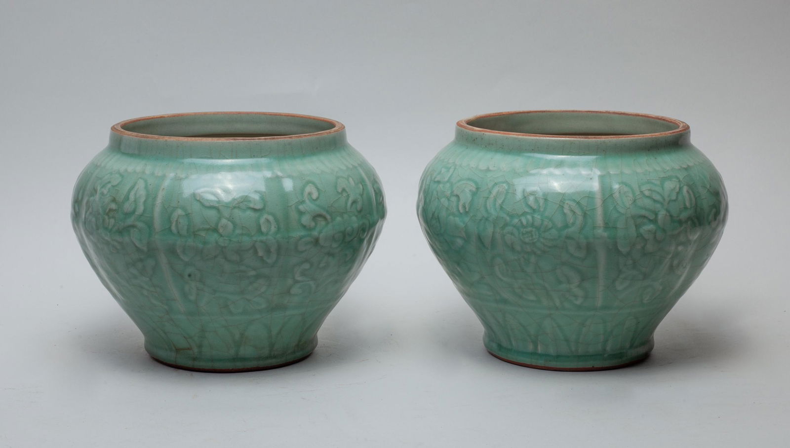 Pair Chinese Longquan Porcelain Jars: The jars carved with flowers and covered in celadon glaze. Approx. 7-9.2 inch (each).