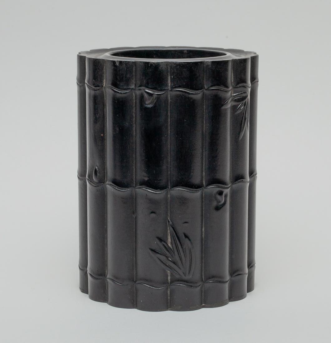 Chinese Hard Wood Bursh Pot: Of cylindrical section, carved around the exterior with bamboo. Approx. 5.8-4.3 inch.