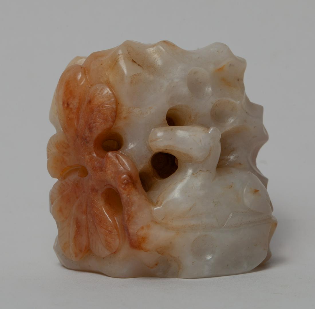 Chinese Russet Jade Sculpture: Carved and reticulated as a crouching horse among tree and rockwork, the stone in a variegated white and russet tone. Approx. 2.2-2.2-1.6 inch.