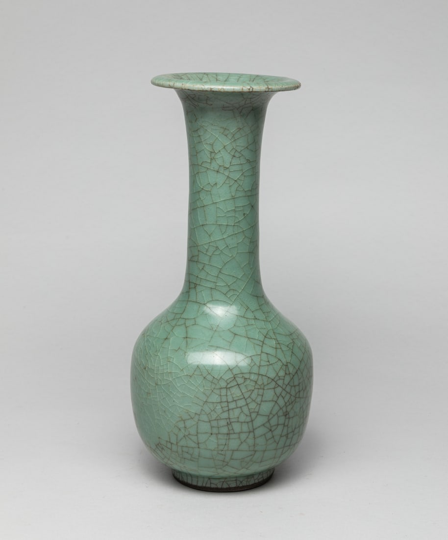Chinese Shipwreck Porcelain Vase: Of ovoid form rising to tall neck and flared rim, covered overall in celadon glaze suffused with a network of crackles. Approx. 10.2-4.6 inch.