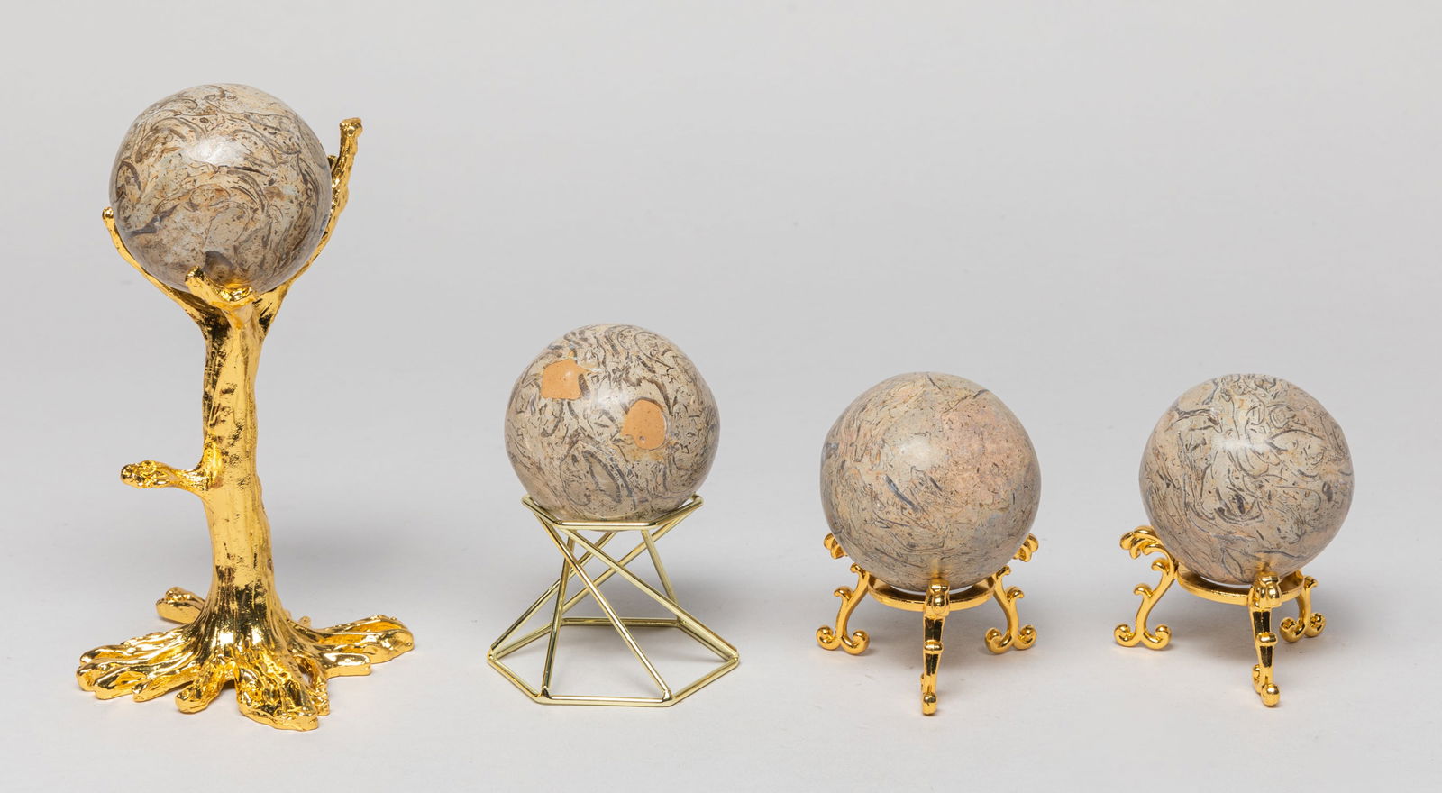 Art House Decor of Dinosaur Fossil Ball: Group of 4 decorative dinosaur fossil type balls, each with a stand. Approx. 2inch W (each ball size).