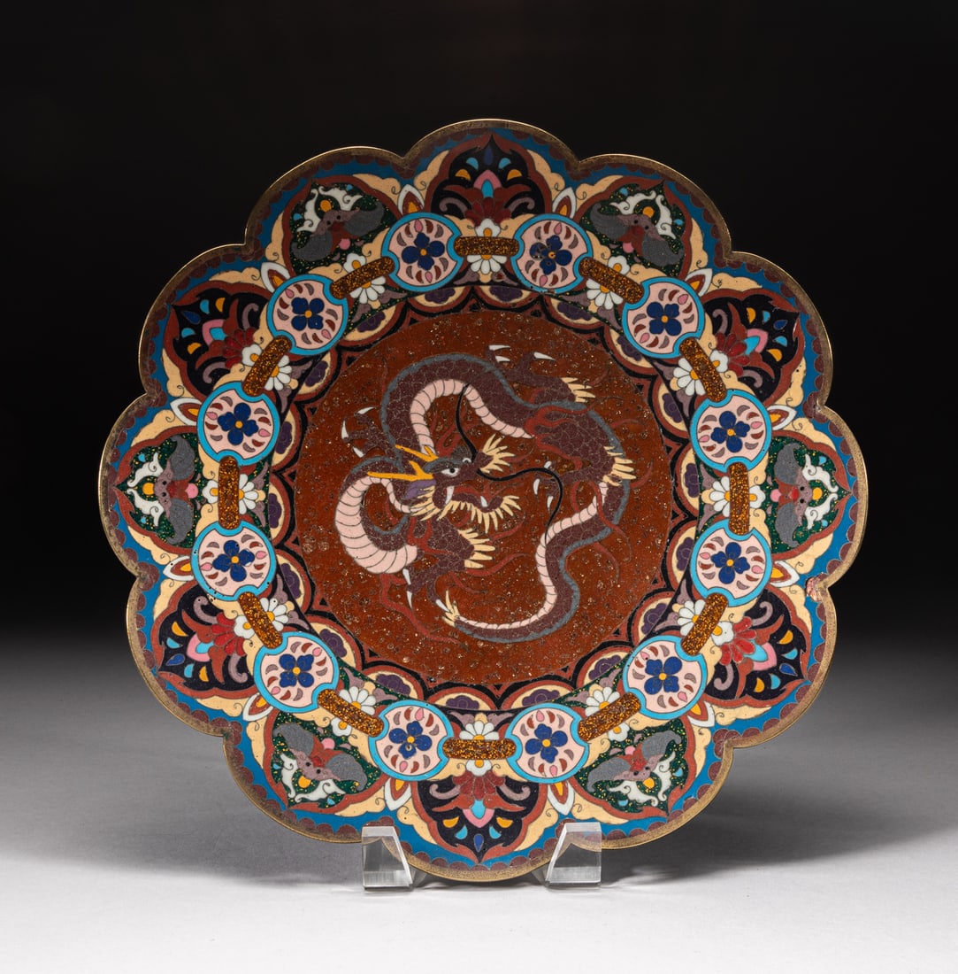 Japanese Meiji Cloisonne Charger: Of flower form, decorated with a sinuous dragon at the centre, surrounded by a band of flowers and bats. Approx. 12inch W.