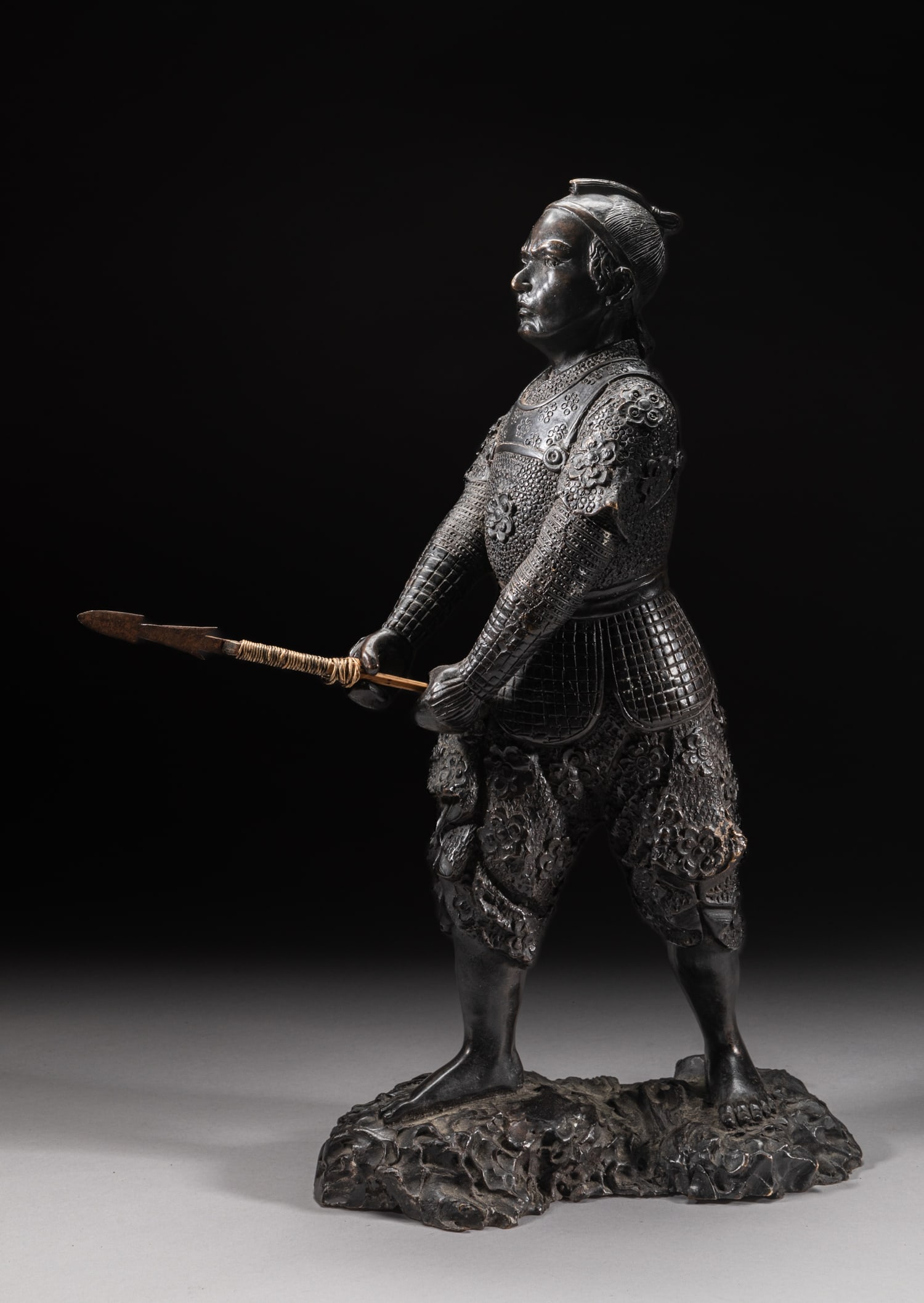 Tall Japanese Sculpture of Meiji Warrior: Modeled as a Japanese warrior standing on rock and hands holding a weapon. Approx. 16-9-5 inch.
