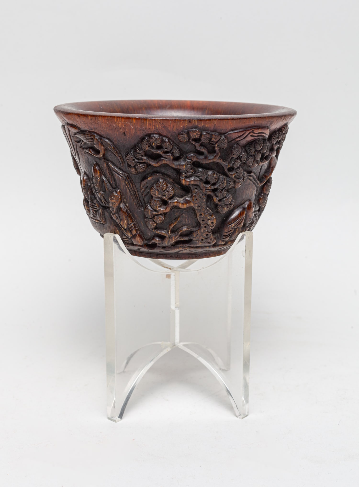 Chinese Export Hand Carved Cup: The cup exterior carved in high relief with figures in landscape with pine trees and mountain. Approx. 5-3 inch.