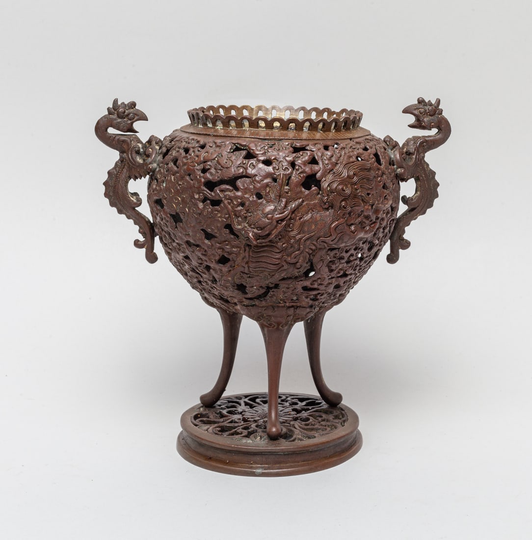 Japanese Meiji Bronze Censer: The ovoid body carved in openwork with a crane and a qilin amidst scrolling clouds, set with two beast handles, the base cast with flower. Approx. 7.7-7.5-5.4 inch.