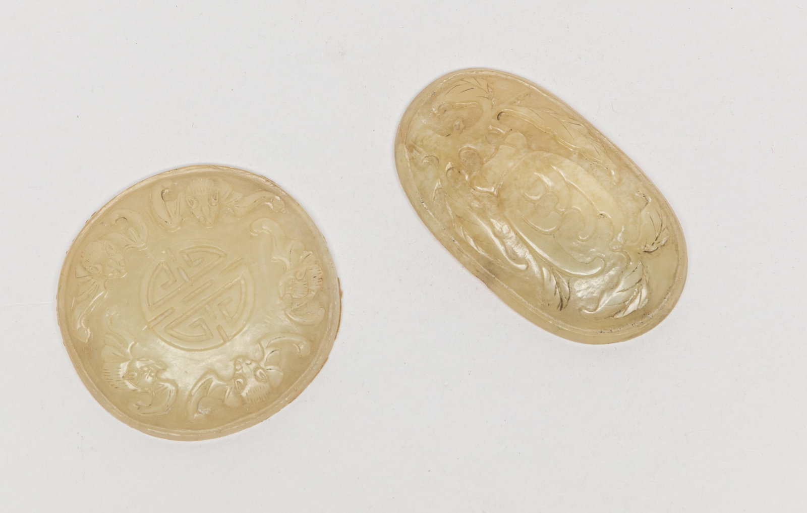 Two Chinese Jade Carvings: Two Chinese jade carvings, one carved with buddha hand fruit, the other carved with five bats around a shou character. Approx. 2.7-2.6 inch (larger).
