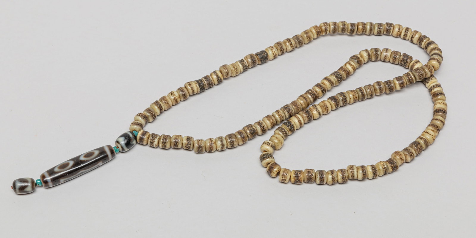 Chinese/ Tibetan Bone & Dzi Bead Necklace: Chinese/Tibetan bone bead necklace, suspended with three dzi beads. Approx. 30inch L.