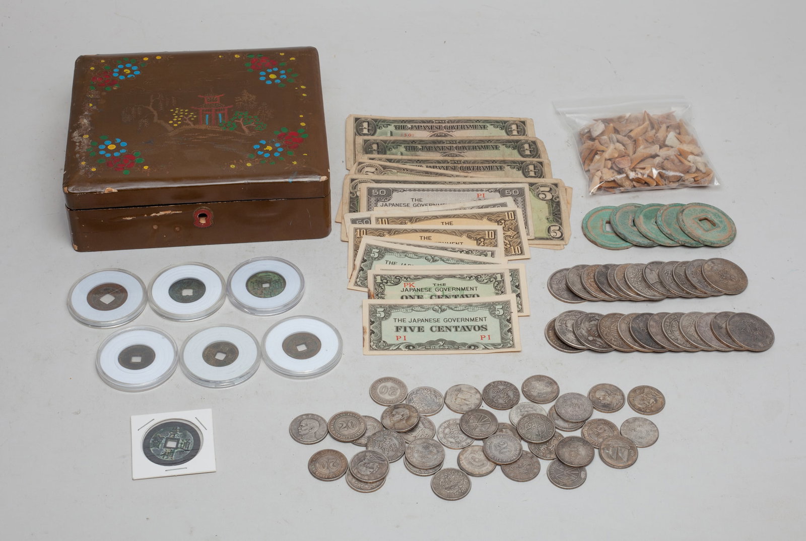 Estate World Coins & Chinese Fengshui Coins: Large group of Chinese Fengshui coins, world coins, Japanese banknotes and animal tooth sculptures, with box. Size varies.