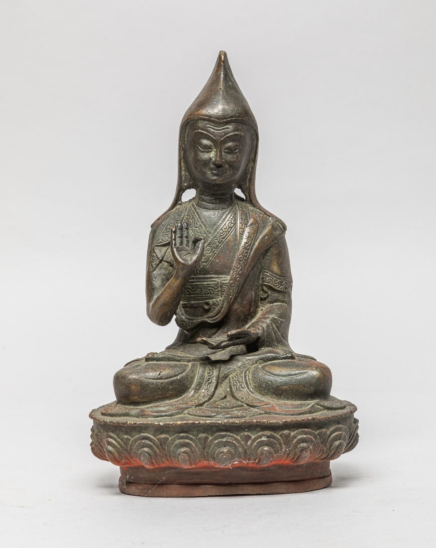 Collectible Chinese Bronze Buddha: The Buddha seated on a lotus base, the left hand holding an implement and the right hand in vitarka mudra, the face with serene expression. Approx. 8.3-4.7-3.5 inch.