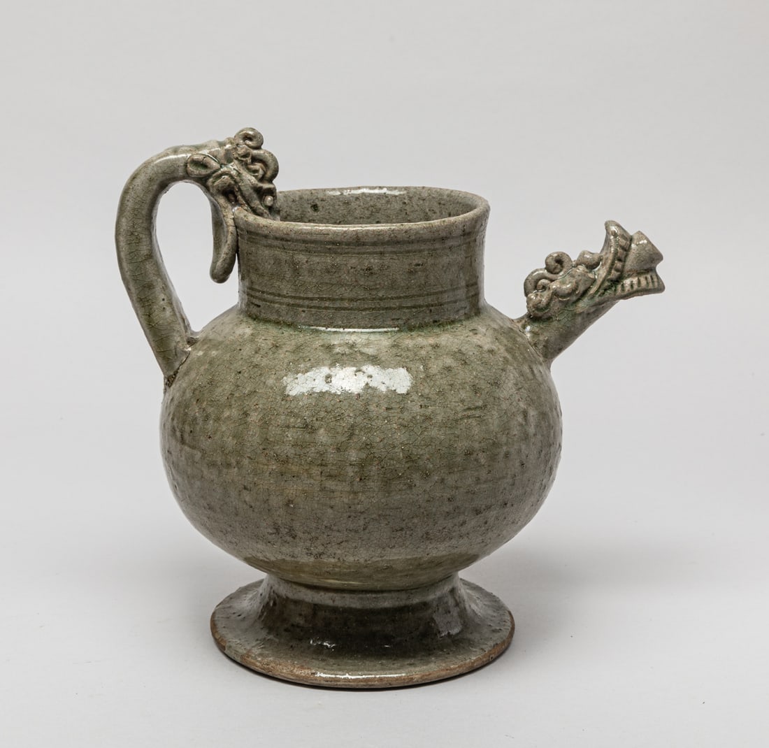 Large Chinese Yue Ware Porcelain Vase: Chinese Yue type porcelain vase set with dragon form handle and spout, the exterior covered in mottled and crackled celadon glaze. Approx. 8.3-8.5-6.5 inch.