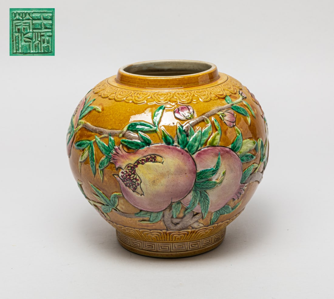 Chinese Export Molded Porcelain Jar: The jar exterior carved and painted with bats and pomegranate branches on brown ground, the bottom carved with a seal mark on turquoise ground. Approx. 6.2-7 inch.