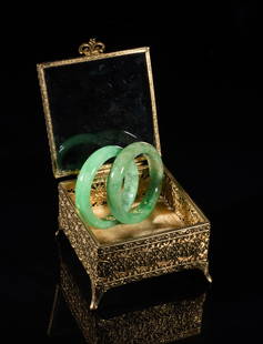 Chinese Export Jade Bangles: Two Chinese jade bangles, with a box. Approx. 2.9inch outer diameter, 2.3inch inner diameter (larger bangle).