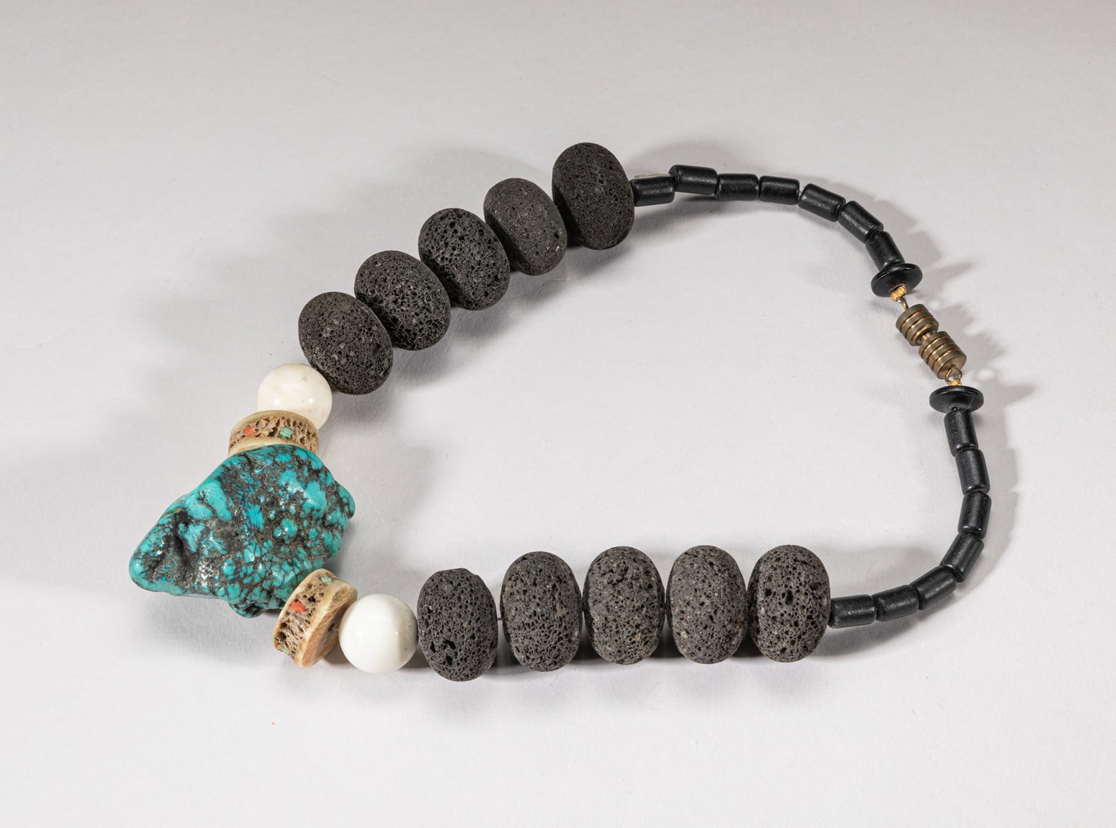 Tibetan Turquoise & Rock Necklace: Tibetan type necklace comprised of large rock beads, shell beads, bone and a turquoise-like nugget. Approx. 14inch L.