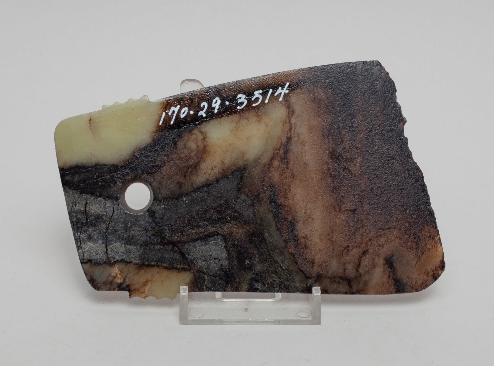 Chinese Jade Carving of Axe: Chinese celadon and black jade carved axe, pierced with an aperture on one end. Approx. Approx. 5-3.3 inch.