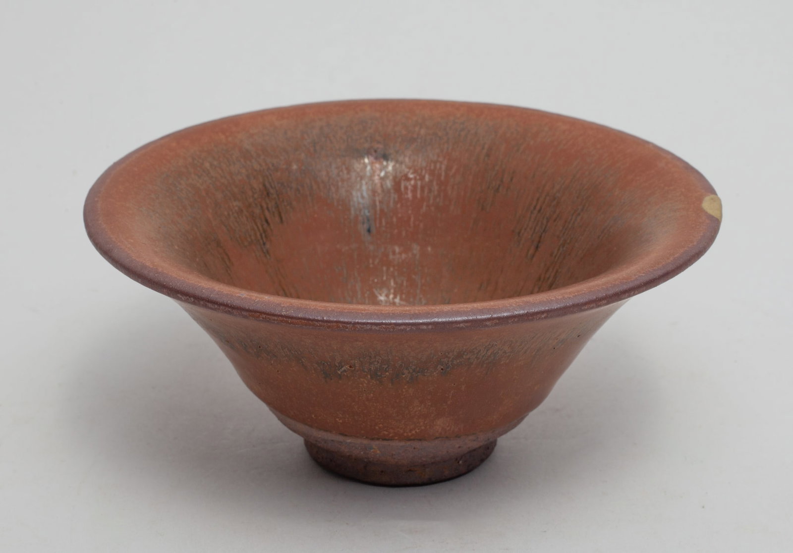 Chinese Jian Stoneware Tea Bowl, Shipwreck: Of conical form with flared rim, applied in streaked brown glaze on the inside and out, stopping at the unglazed foot. Approx. 5-2.2 inch.