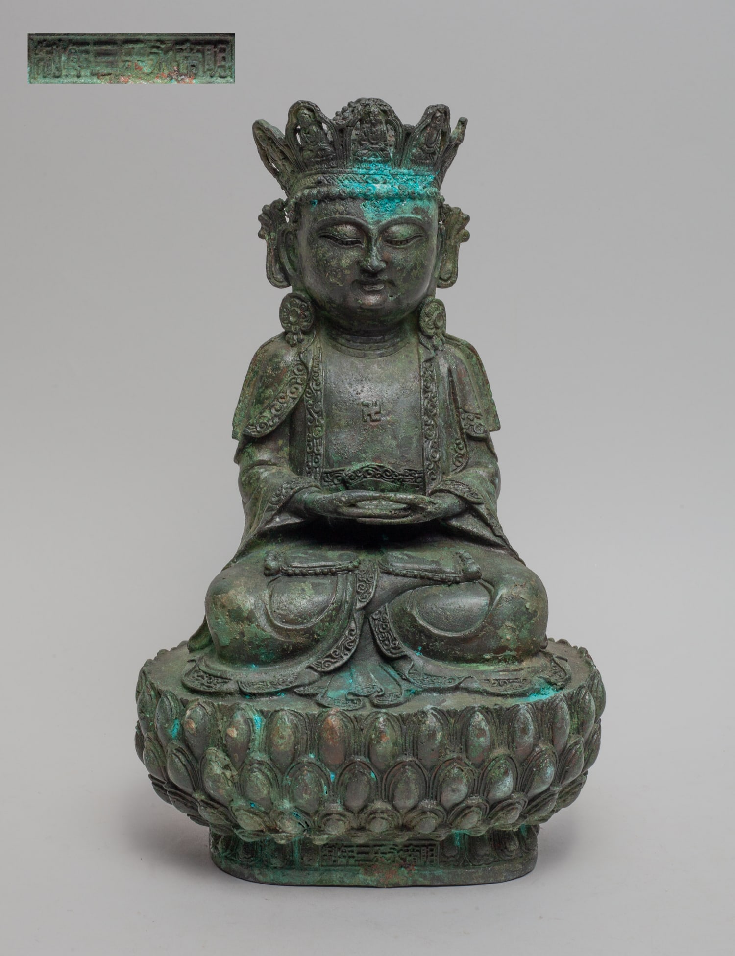 Large Chinese Temple Used Buddha: Chinese metal Buddha cast seated on a lotus base, the hands in dhyana mudra, with a swastika symbol on the chest. Approx. 11.2-6.5-5 inch.
