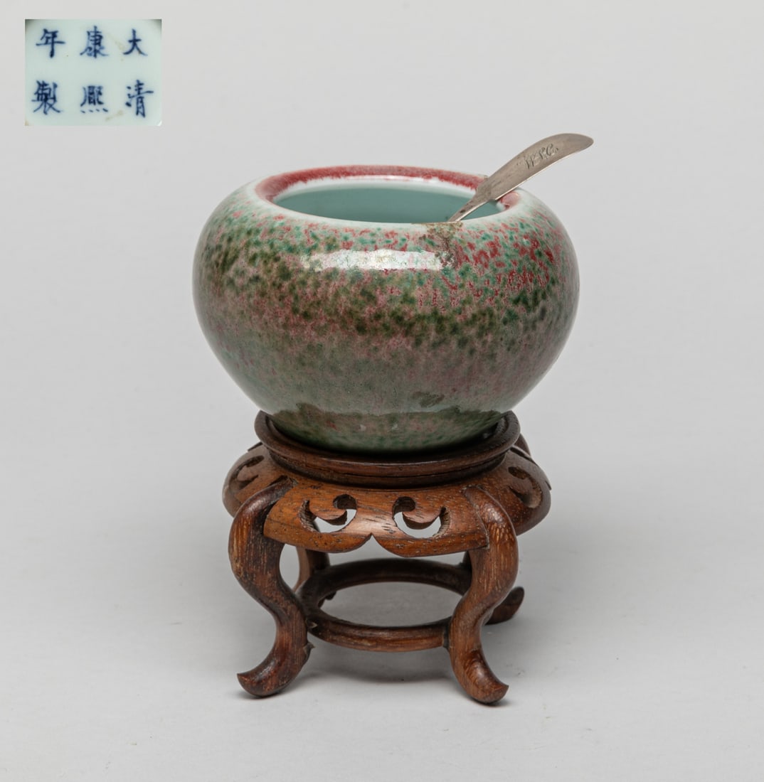 Chinese Flambe Glazed Porcelain Water Pot: Of ovoid form, the exterior applied in mottled red and green glaze, the bottom marked with six characters, with a spoon and a wood stand. Approx. 3.6-2.3 inch (w/o stand). The Estate of the Bam. Len. 