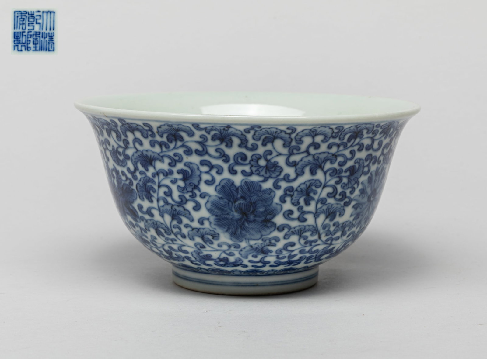 Large Chinese Porcelain Bowl: The exterior decorated with dense leafy lotus foliage, the bottom inscribed with a six-character mark. Approx. 5.8-3.1 inch. The Estate of the Laza. T. Jules. Los Angeles, CA.