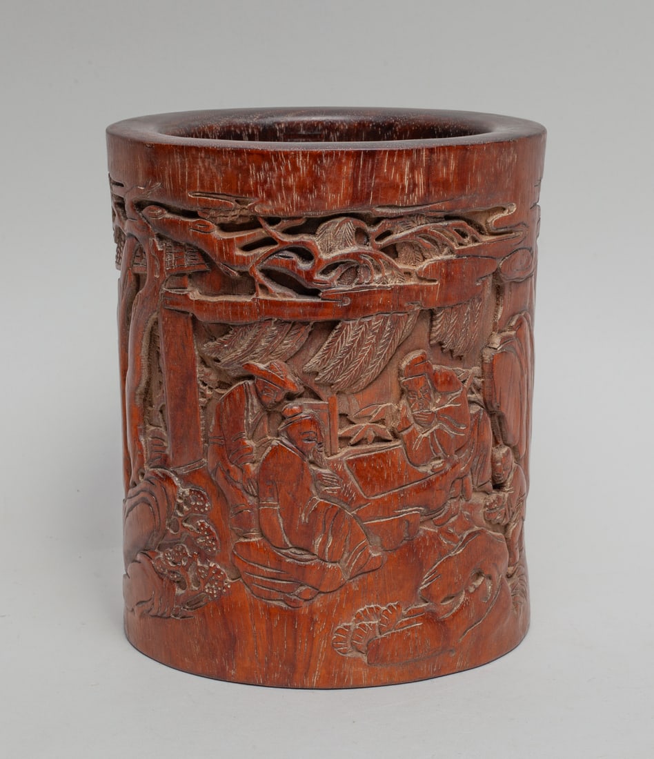 Chinese Wood Carved Brush Pot: Of cylindrical form, the exterior carved with figures in landscape, the bottom pierced with a circular aperture and set with a stopper. Approx. 6.4-5.4 inch.