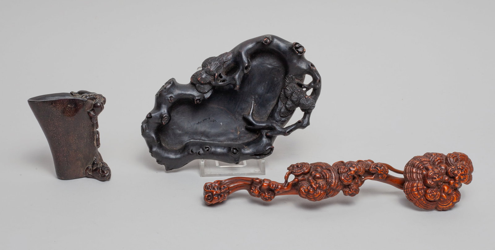 Chinese Wood/ Horn Pieces: Group of 3 wood / horn carvings, one carved in ruyi form, one carved with a pair of beasts, the other carved as a washer with pine tree on the rim. Approx. 5.6-3.5 inch (largest).