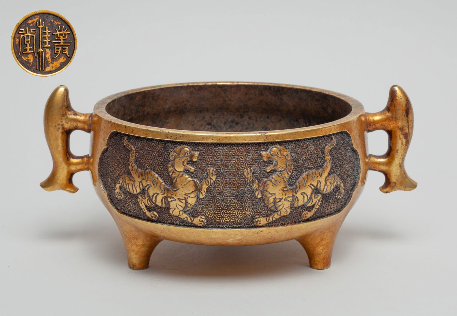 Chinese Gilt Bronze Censer: Of compressed form with three legs and two handles, the exterior carved with pair of beasts, the bottom inscribed with a circular character mark. Approx. 8.5-5.9-3.7 inch.