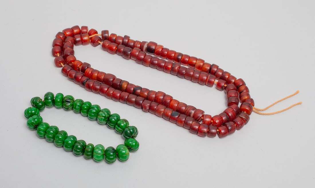Chinese Sino-Tibetan Beads: Including a long reddish bead necklace and a green-color fruit form bead bracelet. Approx. 31inch L (necklace size).