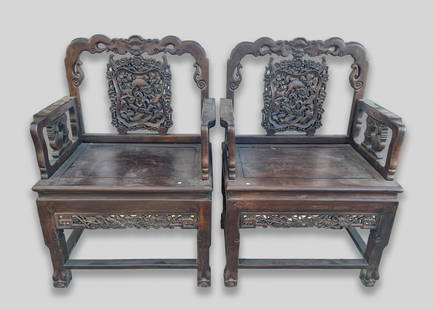 Pair Chinese Heavy Wood Chairs: A pair of collectible Chinese wood carved heavy arm chairs. Approx. 39.2-26-19.2 inch (each).