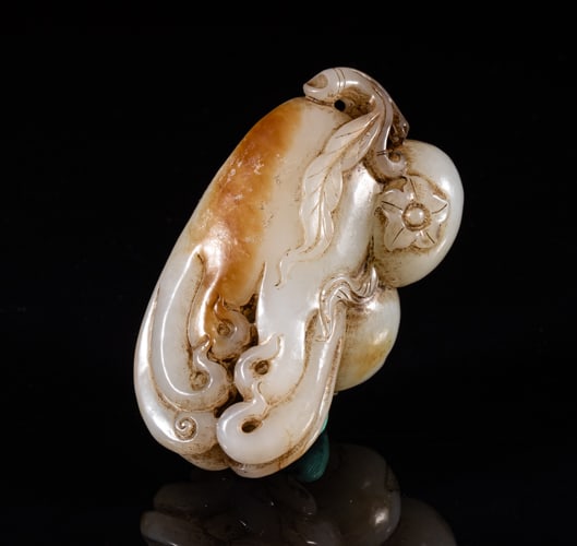 Chinese White Jade Gourd Pendant: Chinese white and russet jade pendant, naturalistically carved as a buddha hand fruit and two pomegranates issuing from a short stem. Approx. 2.6-1.5-1 inch.