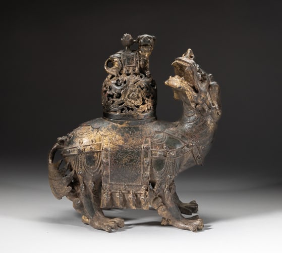 Large Chinese Painted Metal Censer: Chinese painted metal beast form censer, the head turned backwards and the mouth open baring its teeth, the back pierced and set with a lid, carved in openwork with foliage and set with a beast knob. 