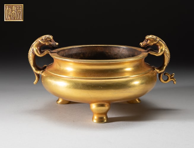 Large Chinese Gilt Bronze Censer: Of compressed form with three legs and two raised beast handles, the underside carved with a three-character mark. Approx. 7.5-6-4 inch.